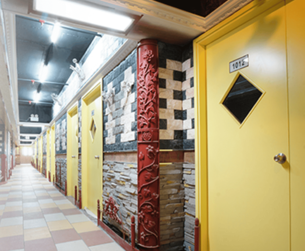 Canaan Mini Storage Tsuen Wan - Storage units with decorative stone walls and yellow doors
