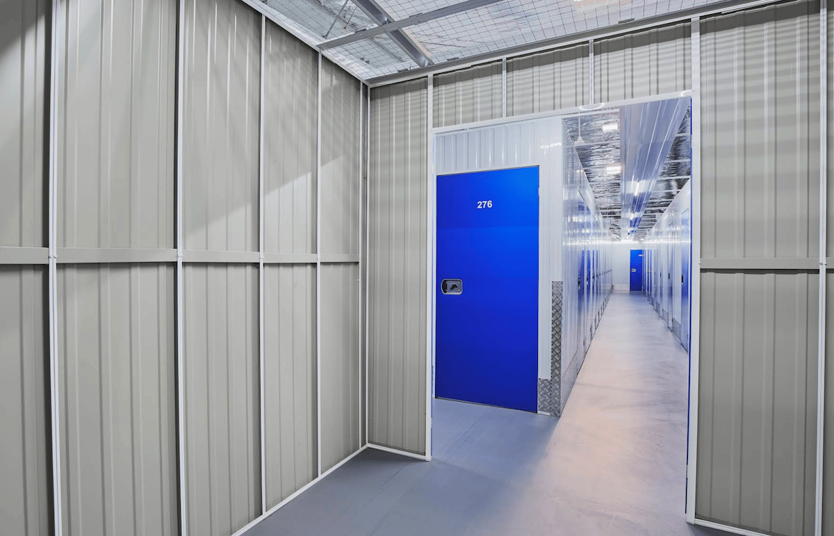 Space Valet Bidrahalli Bangalore — bright corridor with blue self-storage unit doors