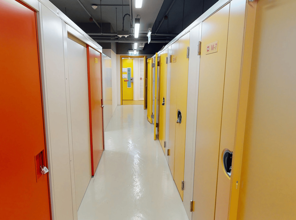 Wilson Storage Kwai Chung - Storage corridor with orange and yellow unit doors